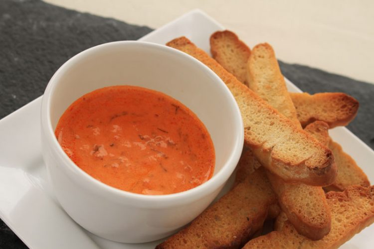 A plate of gazpacho with bread