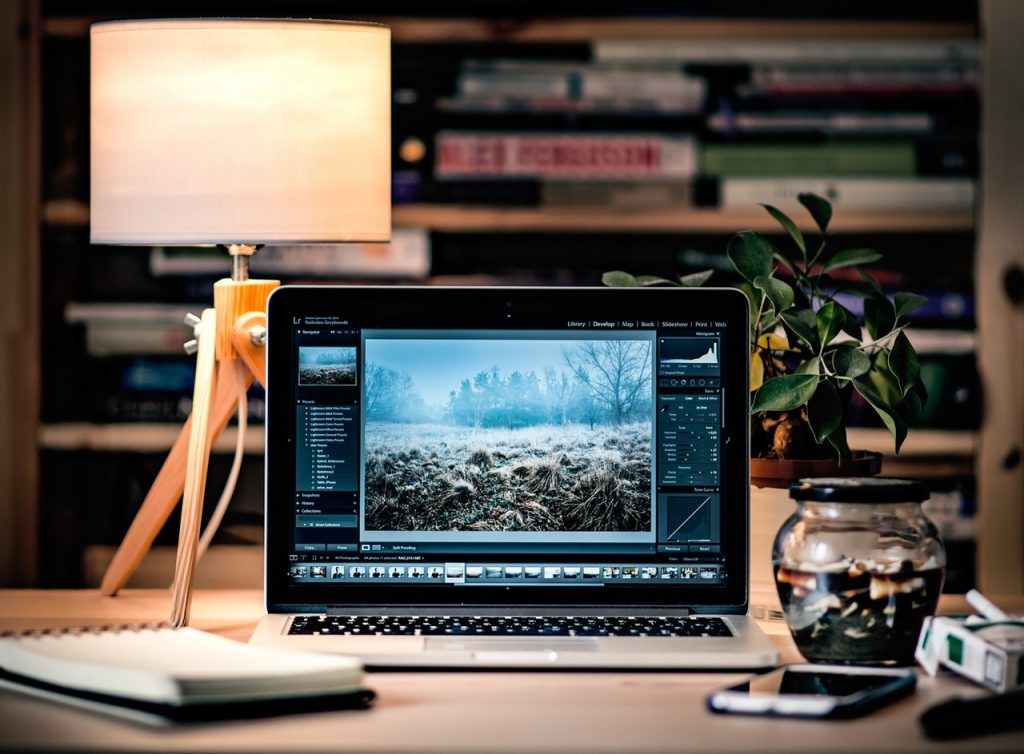 A MacBook Pro with a photo editing software open