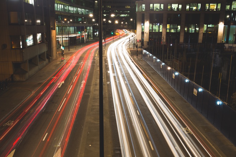 A street with light trails from cars at night