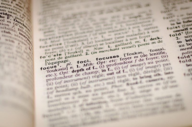 An open dictionary with the word focus in focus