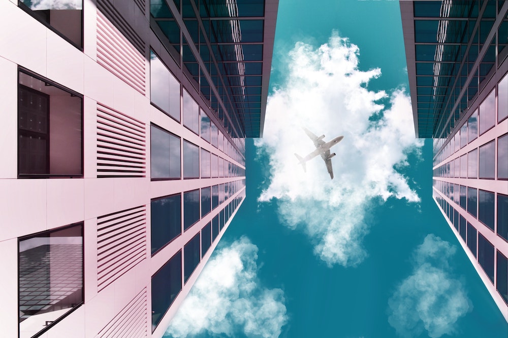 an airplane flying over the buildings